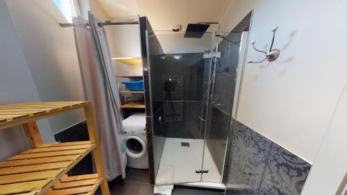 La petite salle de bains est pourvue d'une douche et d'un lave-linge. dans l'établissement Le 23 - Strasbourg, à Strasbourg