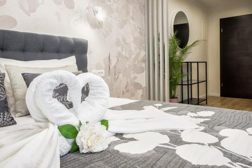 a bed with two towels and flowers on it at Skalinada Sea View in Lokva Rogoznica