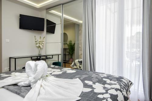 a bedroom with a bed with white towels on it at Skalinada Sea View in Lokva Rogoznica