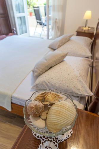 a table with a bowl of shells on a bed at Historic center Hvar town- a few steps from the main square in Hvar