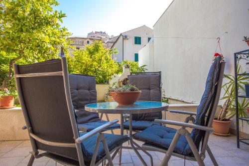 a patio with two chairs and a table on a balcony at Historic center Hvar town- a few steps from the main square in Hvar