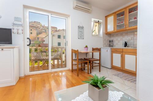 a kitchen with a large window and a table at Historic center Hvar town- a few steps from the main square in Hvar