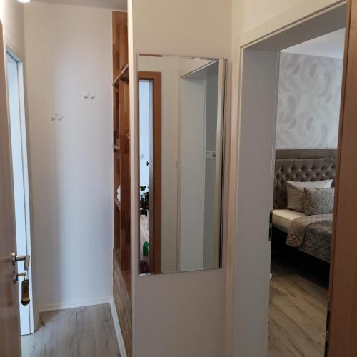 a door leading to a bedroom with a mirror at Hotel Löhr in Baden-Baden