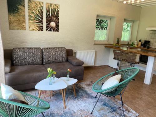 a living room with a couch and two tables and chairs at Ferienwohnungen Sernatinger in Bad Reichenhall