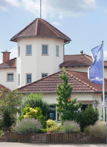 a building with a flag on top of it at Residenz Royal in Sandhausen
