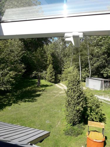 a view of a yard with a bench and trees at Agrohaczow za rzeką Apartament 8-osobowy in Haczów