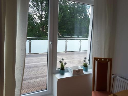 a window with a view of a wooden deck at GästeHaus in Pinneberg