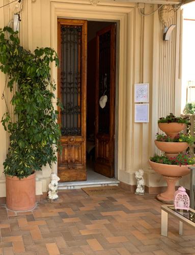 an open door of a building with potted plants at Hotel Nice in Viareggio