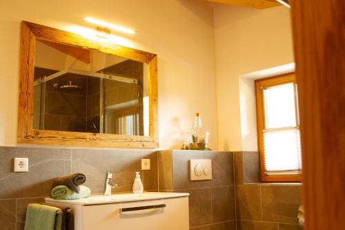 a bathroom with a sink and a mirror at Landhaus Mair in Scharnitz