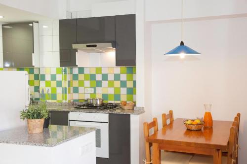 a kitchen with a table and a stove top oven at GoettenMar Platja d'Aro in Platja  d'Aro