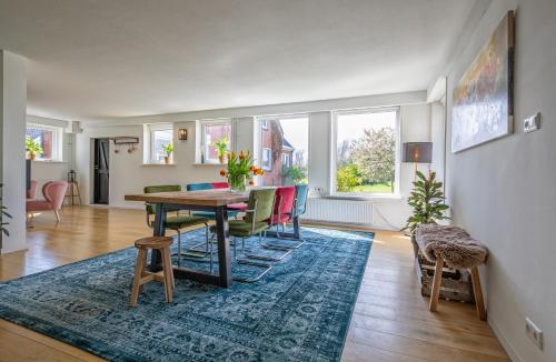 a living room with a dining room table and chairs at Noorderhaecks Suites & Apartment in 't Horntje