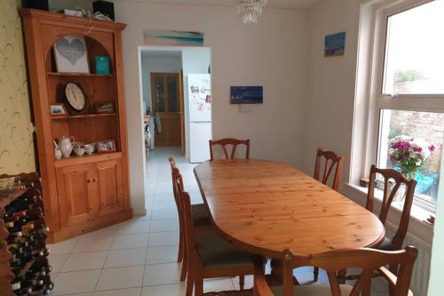a dining room with a wooden table and chairs at Lavender House Weymouth in Weymouth