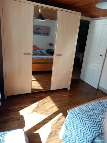 a bedroom with a mirror and a bed in a room at entre mer et campagne in Damgan