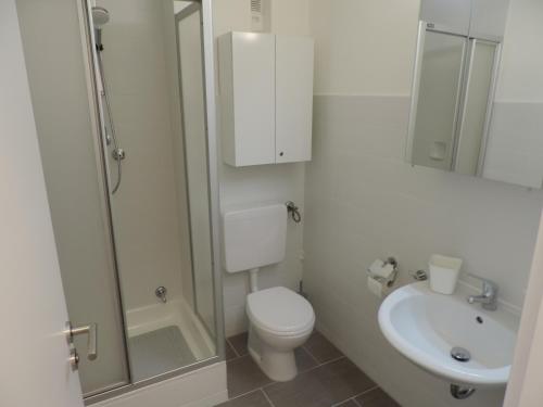 a white bathroom with a toilet and a sink at Your Second Home-5 in Sindelfingen