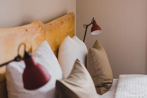 a bedroom with a bed with pillows and a lamp at Hotel Villa Bodeblick in Schierke