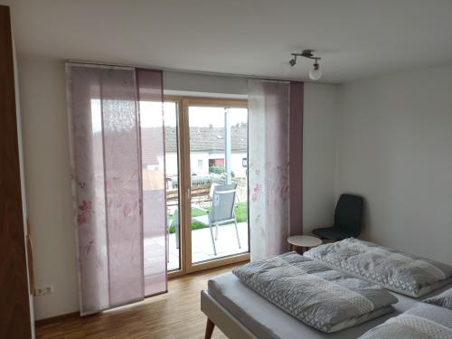 a bedroom with a bed and a sliding glass door at Hengnau 46, Ferienwohnung Stiefel EG in Hengnau