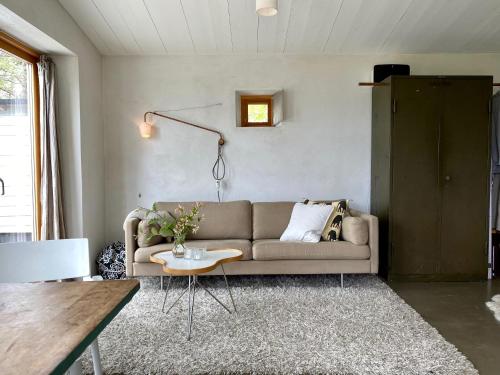 a living room with a couch and a table at Kruthuset in Visby