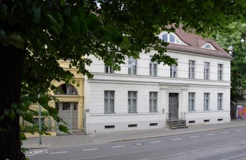 a large white building on the side of a street at Zur Eiche Potsdam in Potsdam