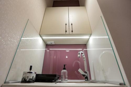 a bathroom with a sink and a mirror at Different Apartments in Niš