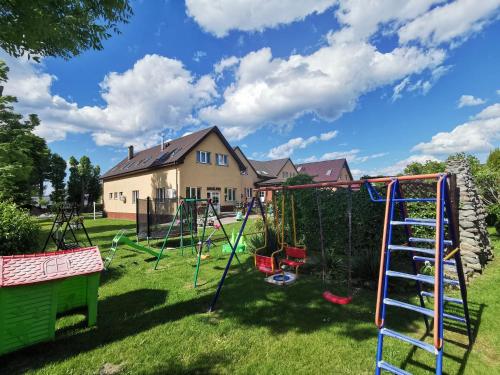 a yard with a playground with a slide at Chata Rybaka in Ustronie Morskie