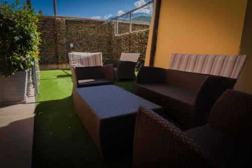 a group of chairs and tables in a patio at Residence Desiree in Riva del Garda