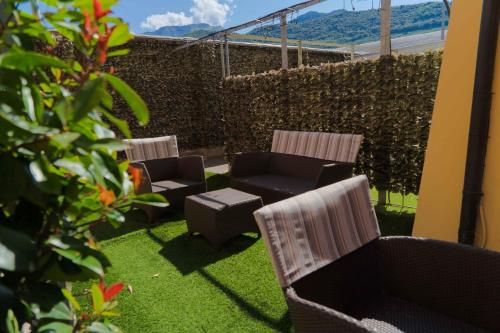 two chairs and a couch in a yard with grass at Residence Desiree in Riva del Garda