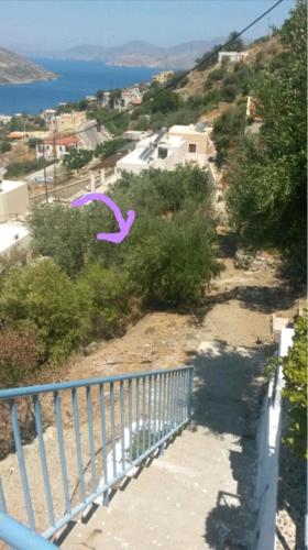 a purple kite flying in the air over a hill at Elsa's house in Kalymnos
