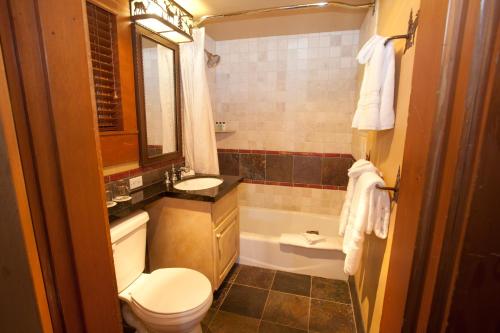 a bathroom with a toilet and a sink and a tub at Jenny Lake Lodge in Beaver Creek