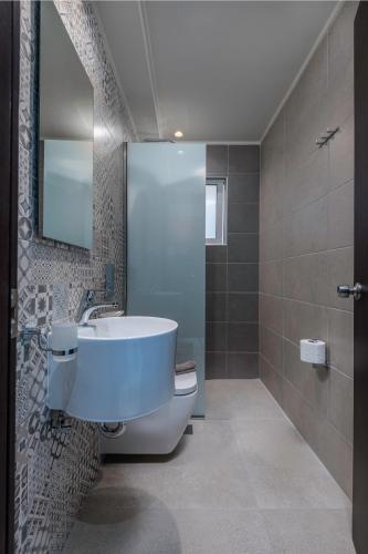 a bathroom with a sink and a mirror at Olympia Hotel in Kos Town