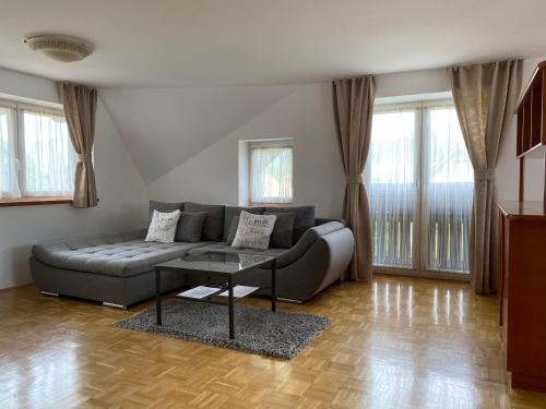 a living room with a couch and a table at Apartments Vila Cvetka Bled in Bled