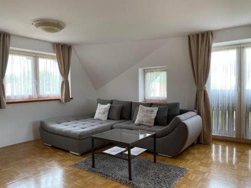 a living room with a couch and a table at Apartments Vila Cvetka Bled in Bled