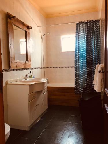 a bathroom with a sink and a bath tub at Carrapateira Lodge in Carrapateira