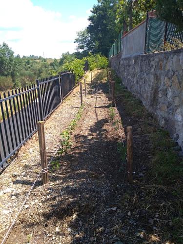 a fence next to a stone wall at La Locanda dei Cavalieri in Mormanno