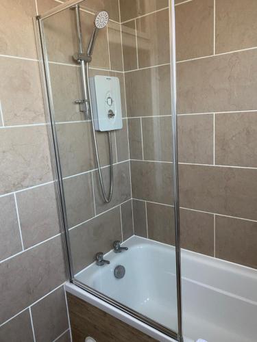 y baño con ducha y bañera. en The garden flat en Torquay