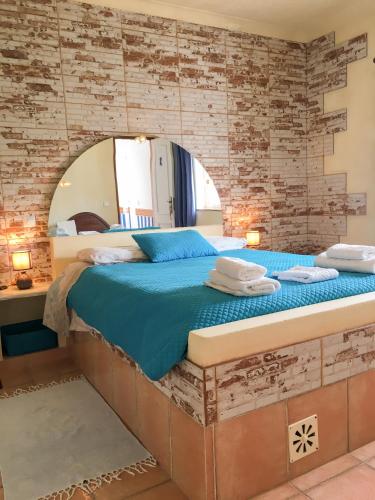 a bedroom with a bed with a mirror on the wall at Carrapateira Lodge in Carrapateira