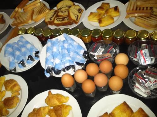 a table topped with plates of eggs and bread at Hotel Erotas in Agios Dimitrios