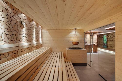 a sauna with a wooden bench in a room at ADLER HÄUSERN Gourmet & Spa Hotel in Häusern