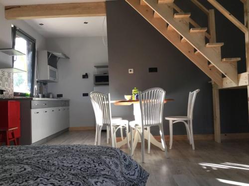 a kitchen and dining room with a table and chairs at Marzeniec w Beskidzie Niskim in Wapienne