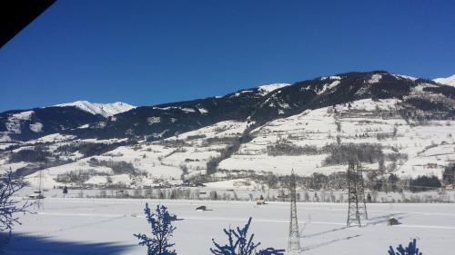 a snow covered mountain in front of a mountain at Apartments Teglbauernhof, Hütte, Chalet, Mobilheim, Appartement, Ferienwohnung, Pension, Urlaub in Uttendorf