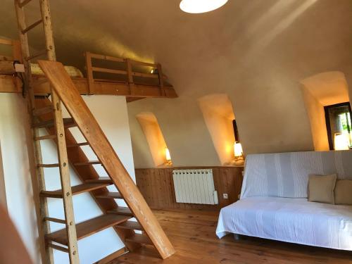 a bedroom with two bunk beds and a ladder at Le gite du Larzac à Brunas in Creissels