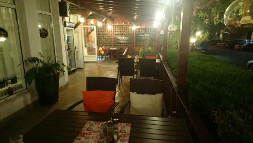 a restaurant with a table and chairs on a patio at Victoria Family Hotel in Balchik