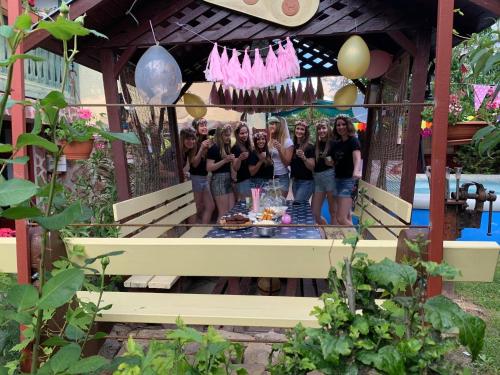 a group of girls posing for a picture in a gazebo at Ádám Apartman in Balatonföldvár