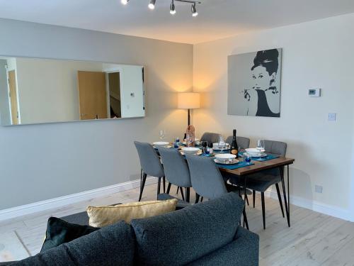 a living room with a dining room table and chairs at City Bridge Townhouse 4 in Newcastle upon Tyne