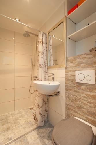 a bathroom with a sink and a toilet at CASASdeCASPER - Studio Alkmaar in Alkmaar