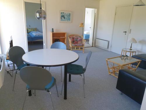 a living room with a table and chairs at Feriestedet Skovly in Klemensker