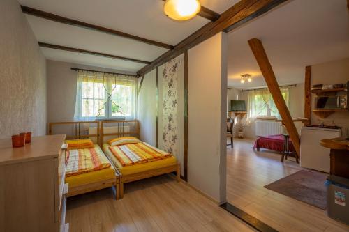 a small bedroom with a bed and a kitchen at U Robsona in Szklarska Poręba