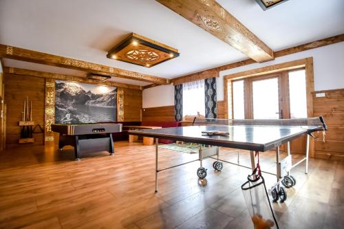 a room with a ping pong table and a piano at Willa Tatra House in Zakopane