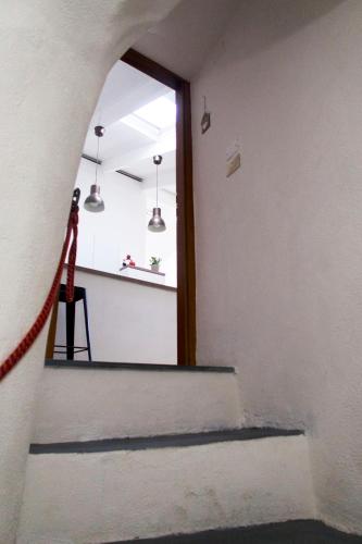 a hallway with a door and a mirror at La Casetta di Vale in Dolceacqua