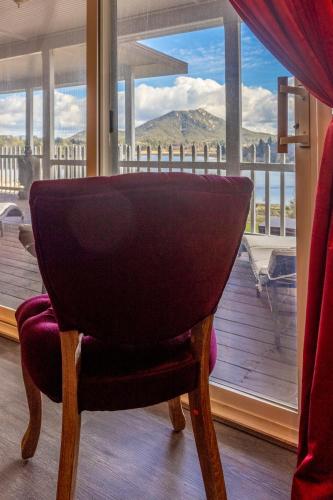a chair in front of a window with a view at Quiet Mind Mountain Lodge, Retreat & Spa in Julian
