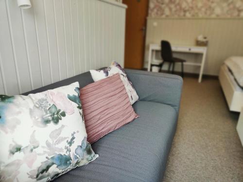 a blue couch with two pillows on it at Penzion Bílá voda in Harrachov